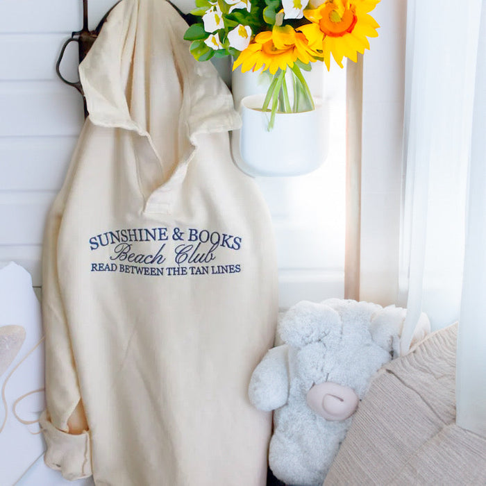 JOCOink Sunshine and books embroidered on pale blue collared sweatshirt | Lola Monroe Boutique