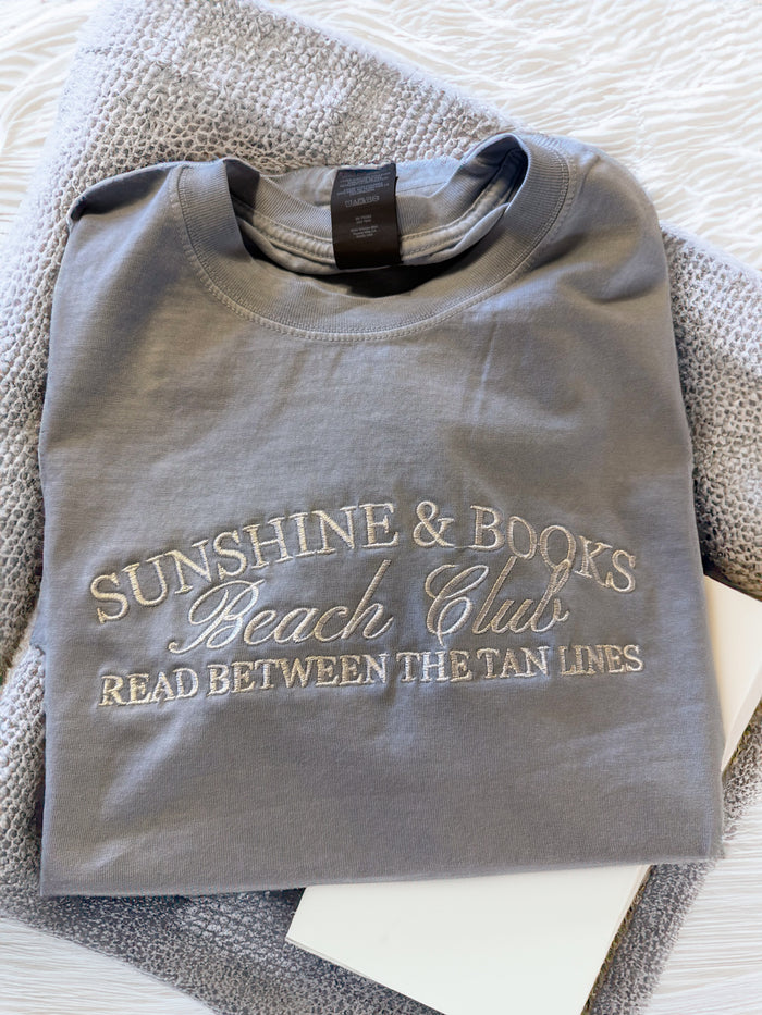JOCOink Sunshine and books embroidered on pale blue Bella Canvas tee | Lola Monroe Boutique